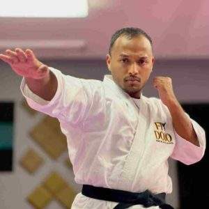 Sensei Anuj demonstrating a blocking technique during a taekwondo class at Fitdojo.